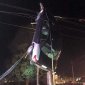 Car Hangs From Telephone Pole