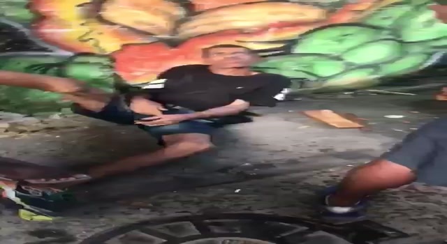 man being beaten with clubs