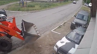 Man fixing his car crushed by front loader