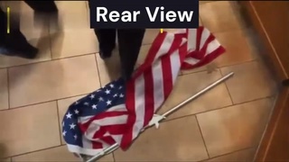 Angry Cop Wipes Her Feet On US Flag!