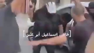Hamas militants with the corpse of an IDF soldier killed