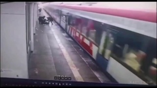Teen shadow-boxing his friend, slips and falls onto train tracks
