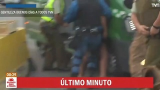 A female criminal takes the guard's gun and shoots them.