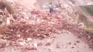 Southwestern northern Guatemalan lady tries to stop a landslide