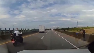 A motorcyclist encounters some road debris