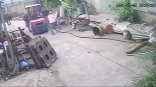 A falling pole hits a man in the head