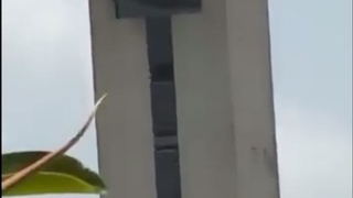 A man attempts to make an incredibly high jump to the water below