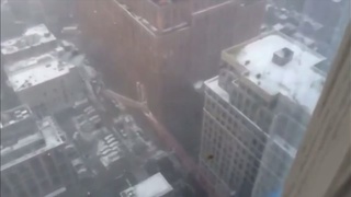 New Yorkers watch a crane fall