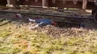 A train hits a bus and cuts a lady in half