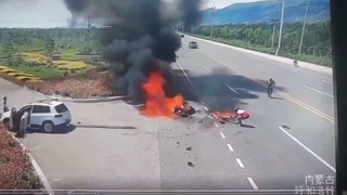 A motorcycle hits a car and then burns