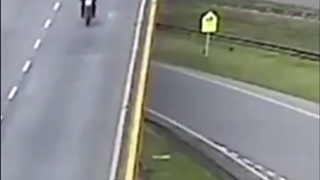 A truck helps a bicyclist exit the highway