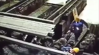 A worker is pinned under a piece of steel