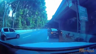 A motorcyclist bounces off the bottom of a car