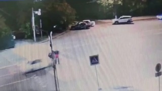 Two guys in a crosswalk are sent for a ride