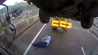 An accident causes a car to fall on a man