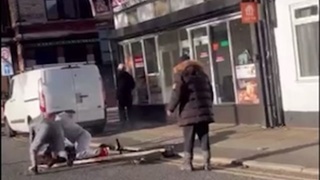 British gentleman have a discussion in front of the pizzeria