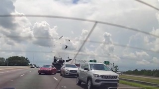 Backed up traffic causes a car to flip