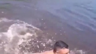 Man swims in very dangerous water....never smile at a crockerdile