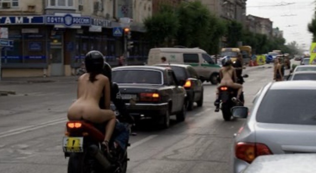 Two naked chicks having fun in public road