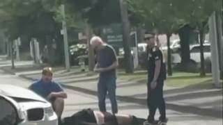 Motorcycle Hangs From Traffic Light Arm
